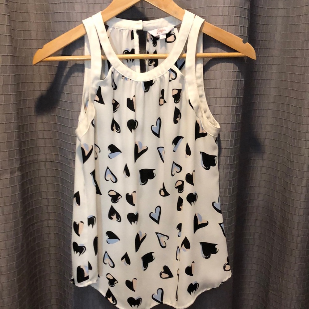 Loose white sleeveless top with blue and pink heart pattern